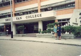 Two unidentified women at the entrance of Academic Building
